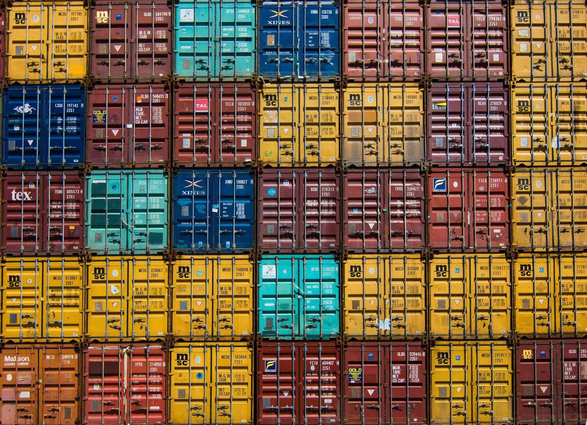 Wall of stacked, colourful shipping containers