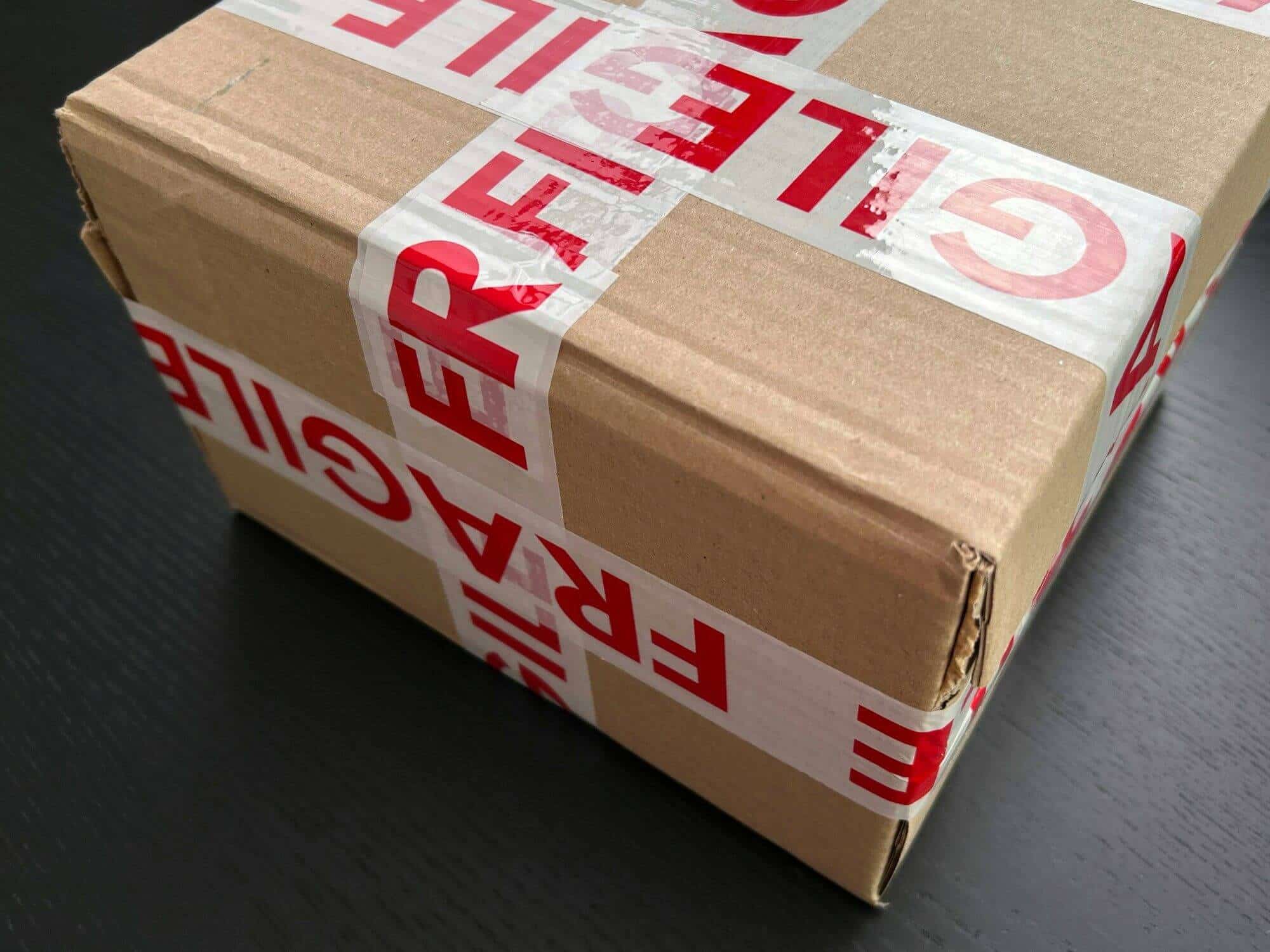 Cardboard carton sealed with red FRAGILE tape